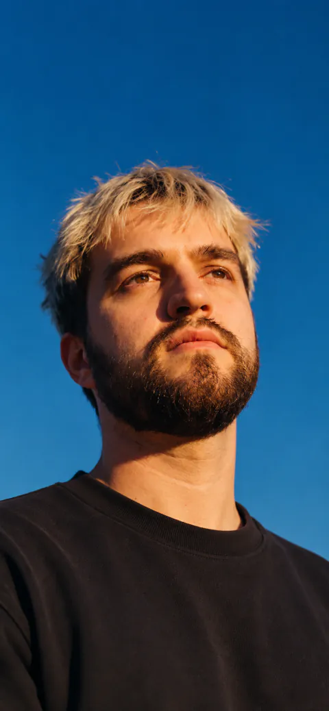 Tvardovsky, sunlit portrait against a blue sky, 2026